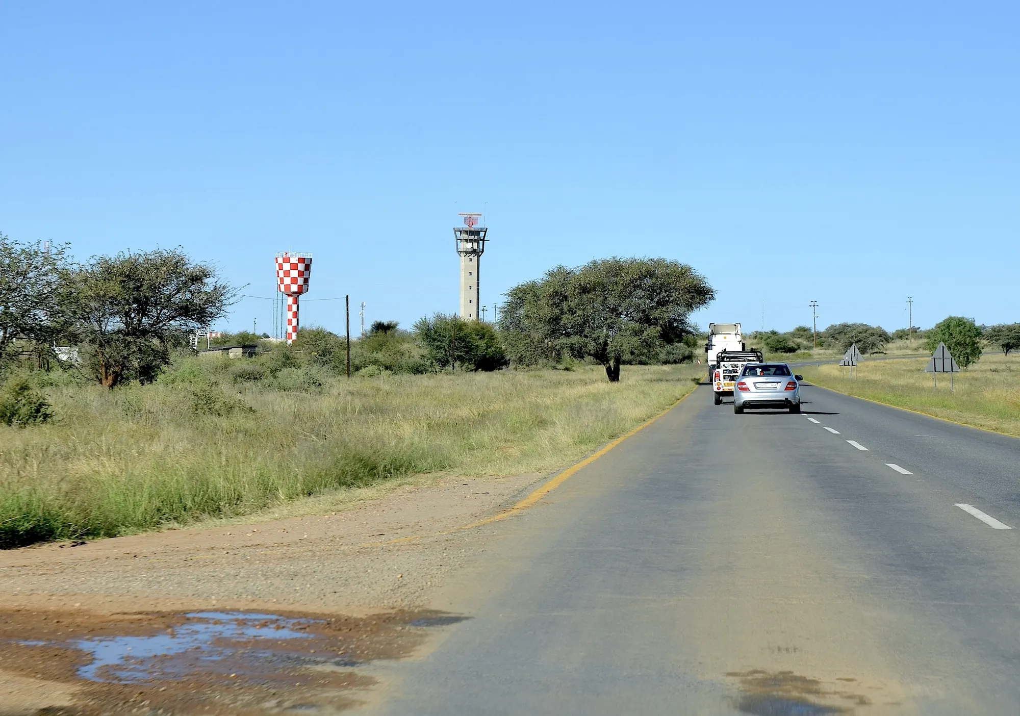The road from Hosea Kutako International Airport, with the control tower and the red and white water tower